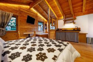 a bedroom with a large bed in a room with wooden walls at Antirouille Casa Vacanze in Aymavilles