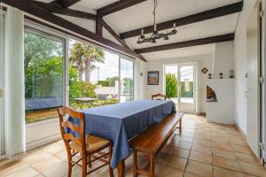 a dining room with a blue table and chairs at Maison d'hôtes Le Grillon in La Brée-les-Bains +51 photos
