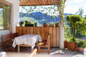 a table and chairs on a patio with a view at Al Cargá San Vigilio di Marebbe in San Vigilio Di Marebbe