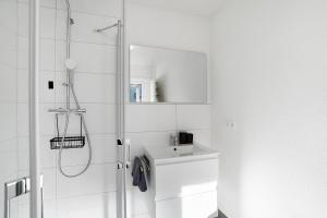 a white bathroom with a sink and a shower at Ferienwohnung am Tanzberg in Oberkirch +29 photos