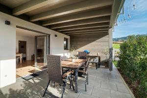 a patio with a wooden table and chairs at Ferienwohnung am Tanzberg in Oberkirch