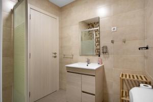 a bathroom with a sink and a shower at Casa Ribeiro Alojamento Local in São Martinho do Porto
