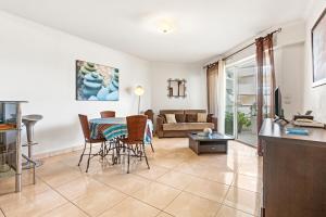 a living room with a table and a couch at Superbe Appartement vue mer in Fréjus