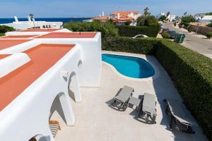 a patio with two chairs and a swimming pool at Ca Sa Mola in Cala Santandria