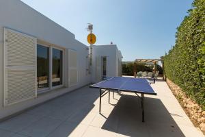 a ping pong table on the patio of a house at Ca Sa Mola in Cala Santandria