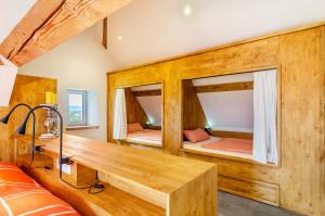 a room with two bunk beds and a wooden desk at Gästehaus Wüpping 3 in Salem