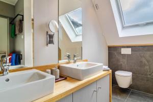 a bathroom with a sink and a toilet at Gästehaus Wüpping 3 in Salem +22 photos
