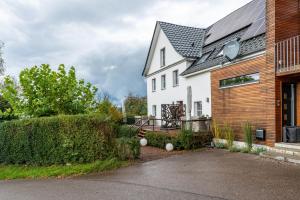 a white house with a black roof at Gästehaus Wüpping 3 in Salem