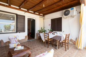 a patio with a table and chairs and a window at Vistamare2 in Cardedu +21 photos