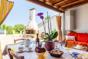 a dining room table with a vase of flowers on it at Vistamare2 in Cardedu