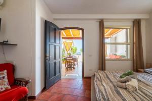 a bedroom with a bed and a door and a chair at Vistamare2 in Cardedu