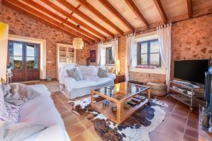 a living room with two couches and a tv at Finca Som Llum in Palma de Mallorca