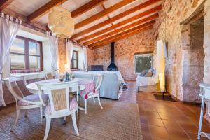 a large living room with a table and chairs at Finca Som Llum in Palma de Mallorca