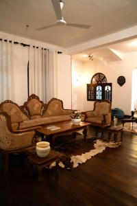 a living room with couches and a coffee table at Villa Di Angelo Negombo in Negombo