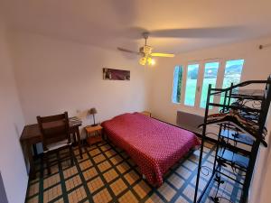 a bedroom with a bunk bed and a desk at Gîte du Poney Fringant in Saint-Paul-Trois-Châteaux