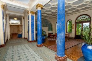 a room with blue columns in a building at Au Temps Suspendu in Aix-les-Bains