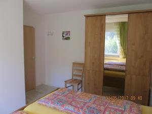 a bedroom with a bed and a closet and a window at Landhaus Erben in Wasserburg