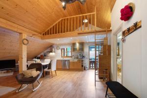 a kitchen and living room with a table and chairs at Landhaus Dachsberg in Wittenschwand