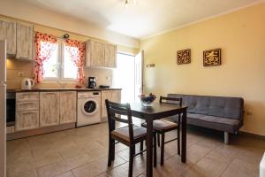a kitchen with a table and a couch at Zoi studio in Kefallonia
