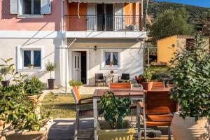 a patio with a table and chairs in front of a house at Zoi studio in Kefallonia