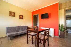 a dining room with a table and a couch at Zoi studio in Kefallonia