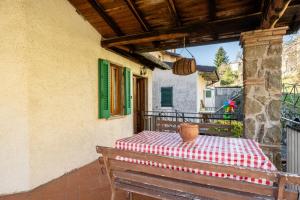 a wooden bench sitting on a balcony with a table at Casa Claire in Prataccio