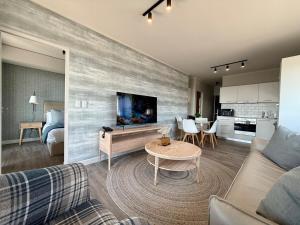 a living room with a couch and a table at Indigo Tide - Mossel Cove Unit 201 in Mossel Bay