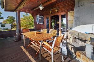 a wooden table and chairs on a wooden deck at Haus-am-Harz Bad Gandersheim in Bad Gandersheim