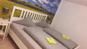 a white couch with pillows on a balcony at Wohnung mit Terasse im Schwarzwald in Seebach