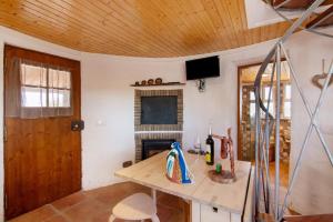 a living room with a wooden ceiling and a table at Casa Moinho Da Eira in Loulé