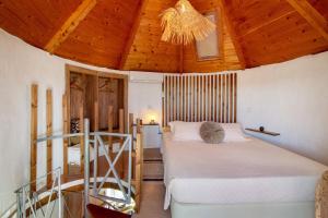 a bedroom with a bed and a wooden ceiling at Casa Moinho Da Eira in Loulé +24 photos