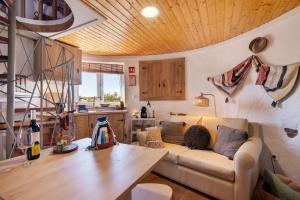 a living room with a couch and a wooden ceiling at Casa Moinho Da Eira in Loulé