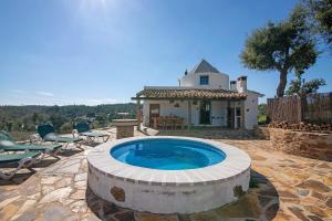 a pool in front of a house with a building at Casa Moinho Da Eira in Loulé