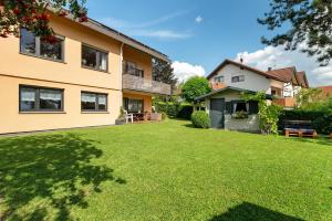 a backyard of a house with a green lawn at Ferienwohnung Carolin in Dornstetten
