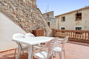 a white table and chairs on a balcony at Casa Encanto con Jacuzzi in Montroig