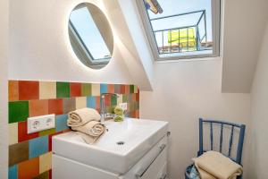a bathroom with a sink and a mirror at Obst- Ferienhof Ragg in Immenstaad am Bodensee +176 photos