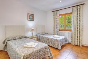 a hotel room with two beds and a window at Villa Luis Vives in Port de Pollensa +34 photos