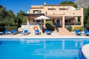 a house with a swimming pool in front of a house at Villa Luis Vives in Port de Pollensa