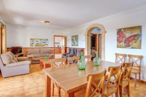 a living room with a table and chairs at Villa Luis Vives in Port de Pollensa