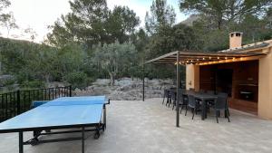 a patio with a table and chairs on a patio at Villa Luis Vives in Port de Pollensa