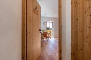 an open door to a dining room with a table at Hof im Thal Apt Lärche in Aldino +20 photos