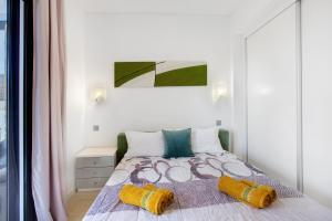 a bedroom with a bed with two pillows on it at Recanto Dourado in Porto Santo