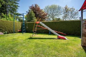 a playground with a slide in a yard at Fewo 14 - Halbinsel Darss - Ostsee in Wieck