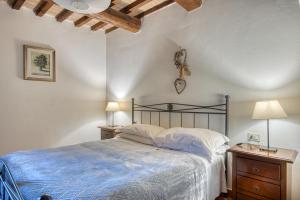 a bedroom with a bed and two night stands with lamps at Lavanda ad Antico Casale '700 in Umbertide +20 photos