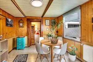 a kitchen with wooden walls and a table and chairs at Haus Luise in Stapelburg