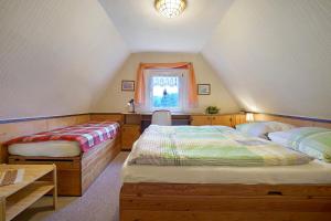 a attic bedroom with two beds and a window at Ferienhaus Carpin in Carpin