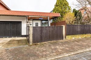 a house with a wooden gate and a fence at Haus Luise in Stapelburg