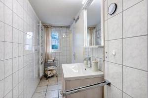 a white bathroom with a sink and a window at Landhaus Dachsberg in Wittenschwand +73 photos
