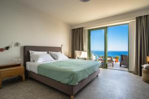a bedroom with a bed and a view of the ocean at Joy Breeze in Kefallonia