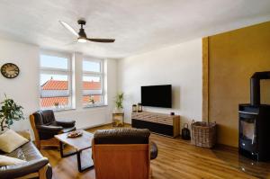 a living room with a couch and a flat screen tv at Ferienwohnung Eichendorff in Nordhausen